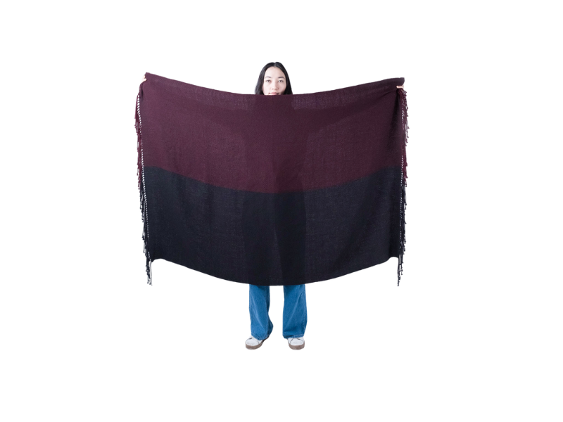 Handwoven alpaca scarf in alternating burgundy and black tones, finished with twisted fringe ends.